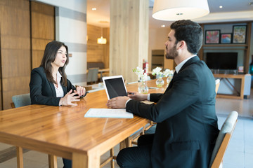 Mid Adult Colleagues Planning In Hotel