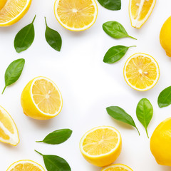 Frame made of fresh lemon and  slices with leaves isolated on white