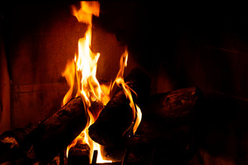 Fototapeta premium Fireplace detail with tall fire flames.