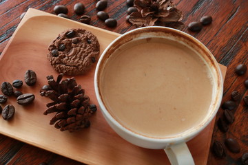 a cup of cappucino coffe on a table ready to drink