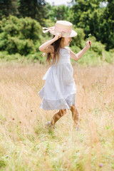 Girl dancing on a golden meadow