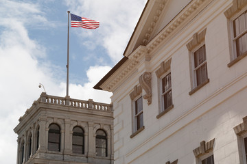 Fototapeta na wymiar Buildings in Charleston, South Carolina and an American flag.