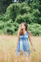 girl with long hair walks across the field