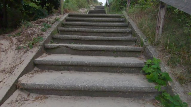 4K slowmotion footage of climbing up the stairs in Groot Valkenisse, Zoutelande, Zeeland, Netherlands.