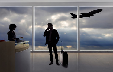 Stressed out businessman passenger arguing with a flight attendant or receptionist at an airport check in counter.  He is angry because of a delayed or cancelled flight.