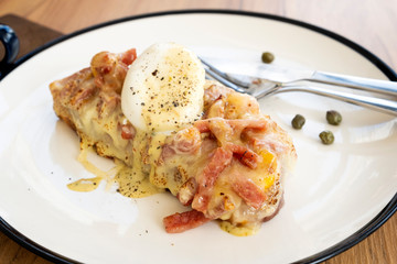 Toast, ham, bacon, cheese and fried eggs for breakfast