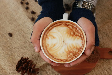 a cup of cappucino coffe on a table ready to drink