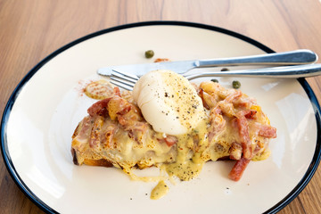 Toast, ham, bacon, cheese and fried eggs for breakfast