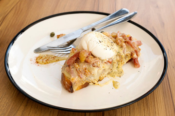 Toast, ham, bacon, cheese and fried eggs for breakfast