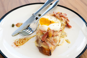 Toast, ham, bacon, cheese and fried eggs for breakfast