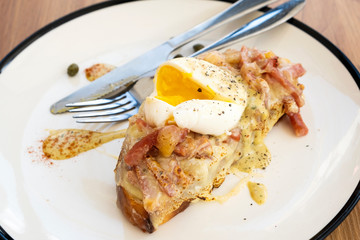 Toast, ham, bacon, cheese and fried eggs for breakfast