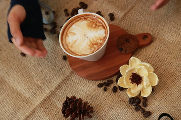 a cup of cappucino coffe on a table ready to drink
