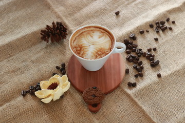 a cup of cappucino coffe on a table ready to drink