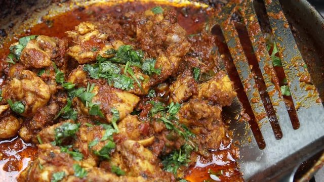 Cooking Tava chicken or skillet Chicken , an appetizer outdoors in a pan on coal