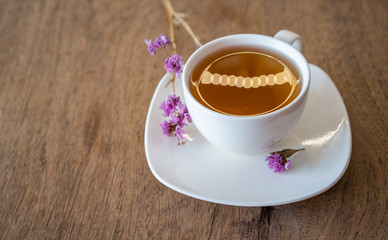 Hot tea on wooden background. White ceramic cups top view closeup, place for text