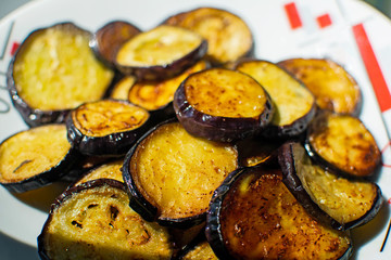 Fried eggplant with garlic on a plate.