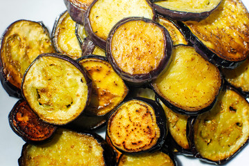 Fried eggplant with garlic on a plate.