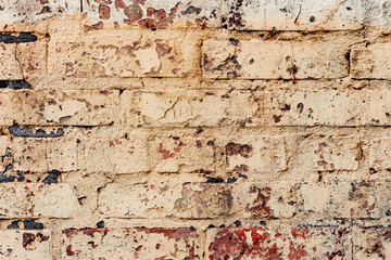 Texture of a brick wall with cracks and scratches which can be used as a background