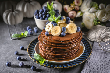 Chocolate pancakes with banana and blueberry