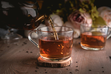 Pouring tea into cup of tea