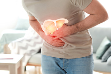 Young man suffering from stomachache at home