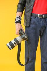 Male photographer on color background