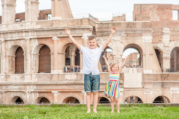 Very happy kids near Coliseum in Rome, Italy. Travel concept