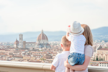 Family traveling. Woman with kids looking on panoramic view of florence, Italy