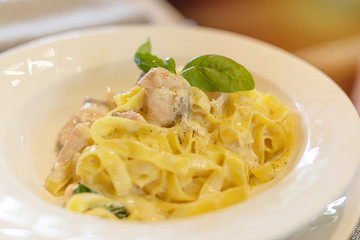 pasta with salmon on a white plate