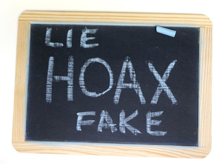 Hoax and fake message on chalkboard
