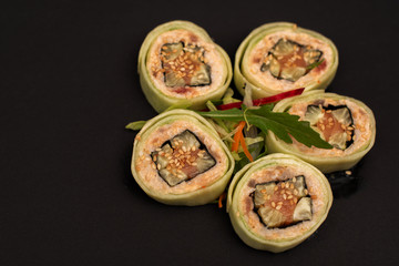 fresh sushi with cucumber and salmon on black background