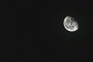 Moon on a dark background. Room for text