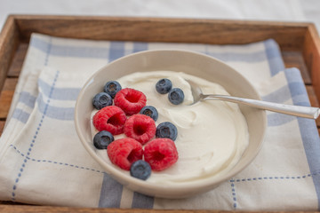 healhty greek Yogurt with fresh berries for breakfast on a table