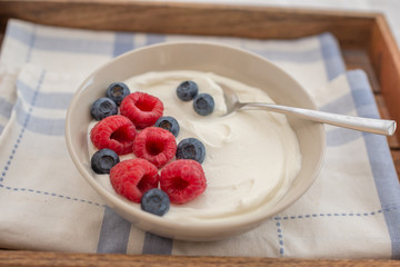 healhty greek Yogurt with fresh berries for breakfast on a table