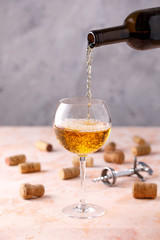 White wine is poured into a glass. The concept of winemaking. Place under your text.