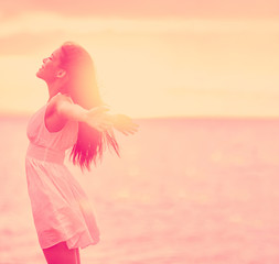 Well-being woman stress free feeling happy emotion with open arms on sunset nature background....
