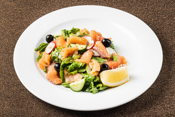 salad with smoked salmon on the white plate