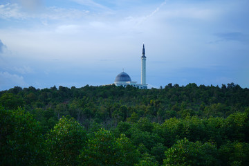 long road to beautiful mosque in glorius sky.  The biggest mosque in Tanjung Pinang, Riau Islands                               