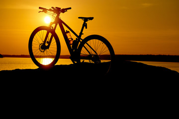 Fototapeta na wymiar silhouette bike on sunrise. Active Lifestyle Concept.