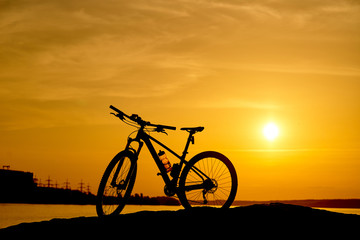 Fototapeta na wymiar silhouette of a bicycle at sunset. Active Lifestyle Concept.