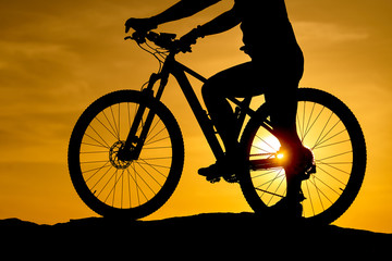 Fototapeta na wymiar Silhouette Young man of cycling on sunset background. Bicycle and ecology lifestyle concept.