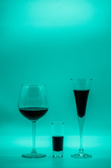Cocktail glasses with blue curacao on blue background