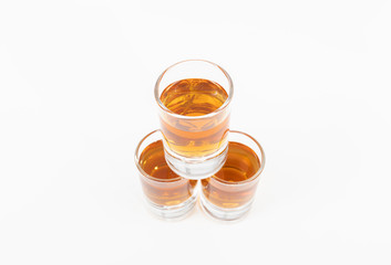 Three whiskey glasses stacked vertically on a white background - Tasty and luxurious whiskey