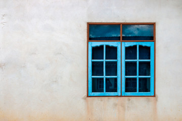 Fototapeta na wymiar Colorful window on a concrete wall