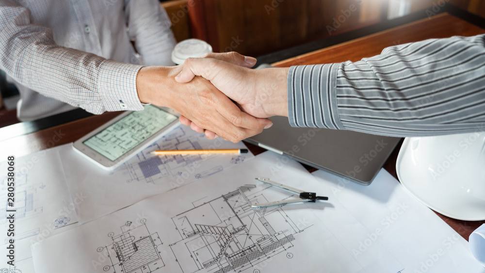 Aufkleber architect and engineer construction workers shaking hands while working for teamwork and cooperation