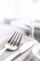 Table set with silver cutlery and glassware. Dinning concept background. Close up.