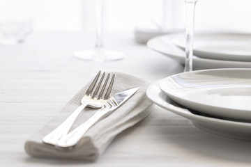 Table set with silver cutlery and glassware. Dinning concept background. Close up.
