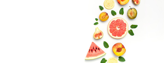 Tropical Summer Fruit Concept. Creative layout made of fresh ripe watermelon, peach, plum, fig, lemon, grapefruit and mint leaves on white background. Flat lay, top view, copy space. Food background