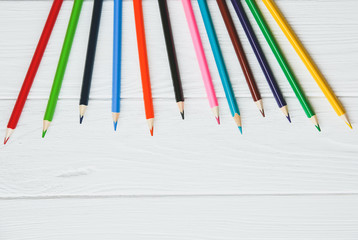 Obraz premium Colorful pencils on white wooden background. back to school concept. Art creative photo.