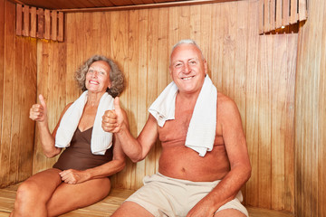 Happy seniors couple is enjoying the sauna